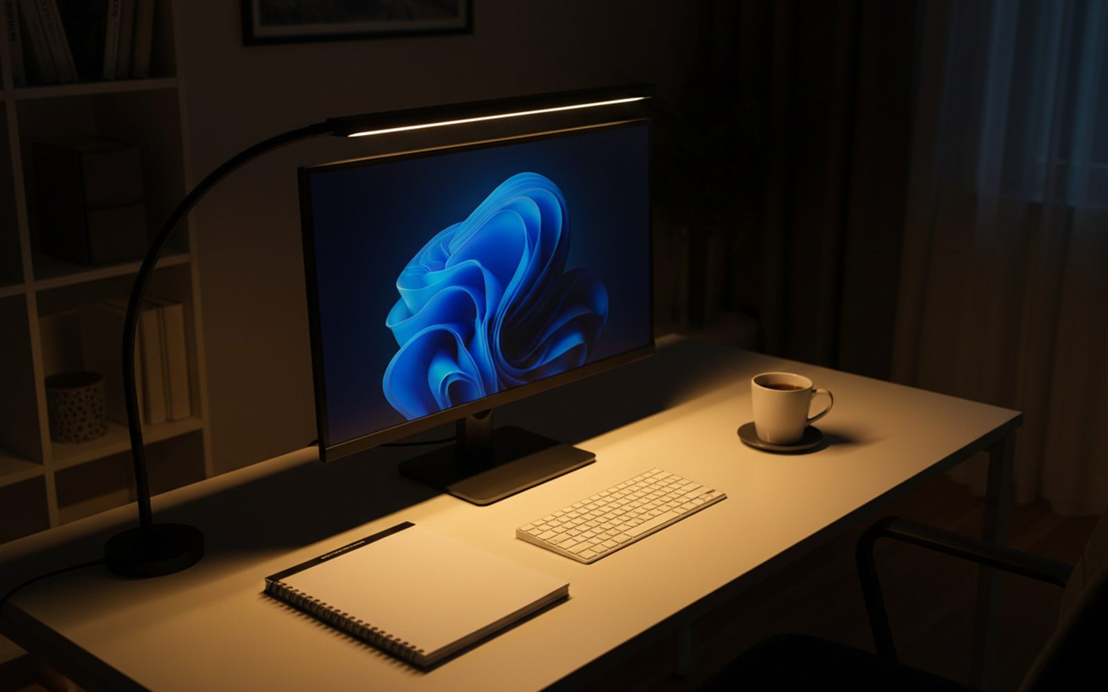 A wide LED light bar arches over a monitor and bathes a tidy desk in warm, even evening light.